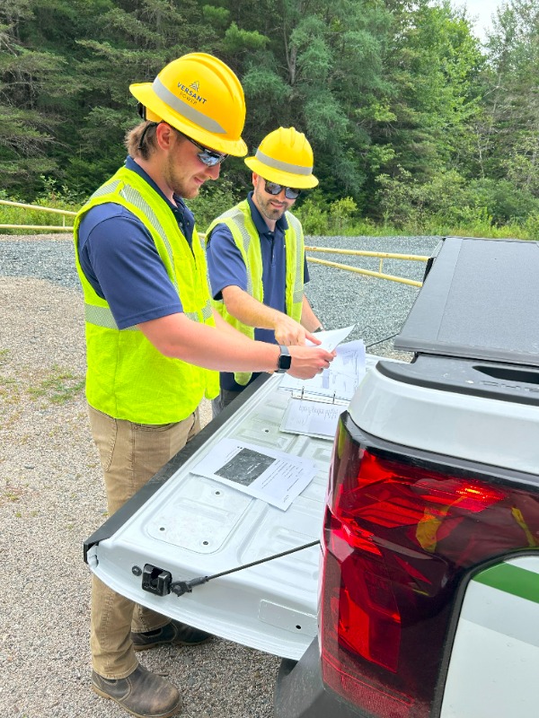 Andrew Otis, Versant Power T&D project manager, and Jacob Larsen look at documents detailing the work that will be taking place in the Toddy Pond area in the upcoming weeks.