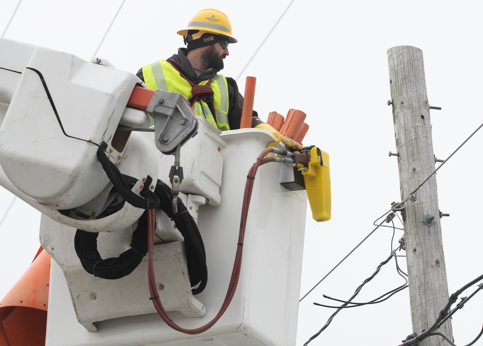 a versant power worker in a bucket truck