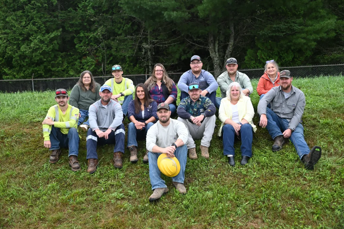Versant Power team members posing for a group photo outdoors during a community or training event.